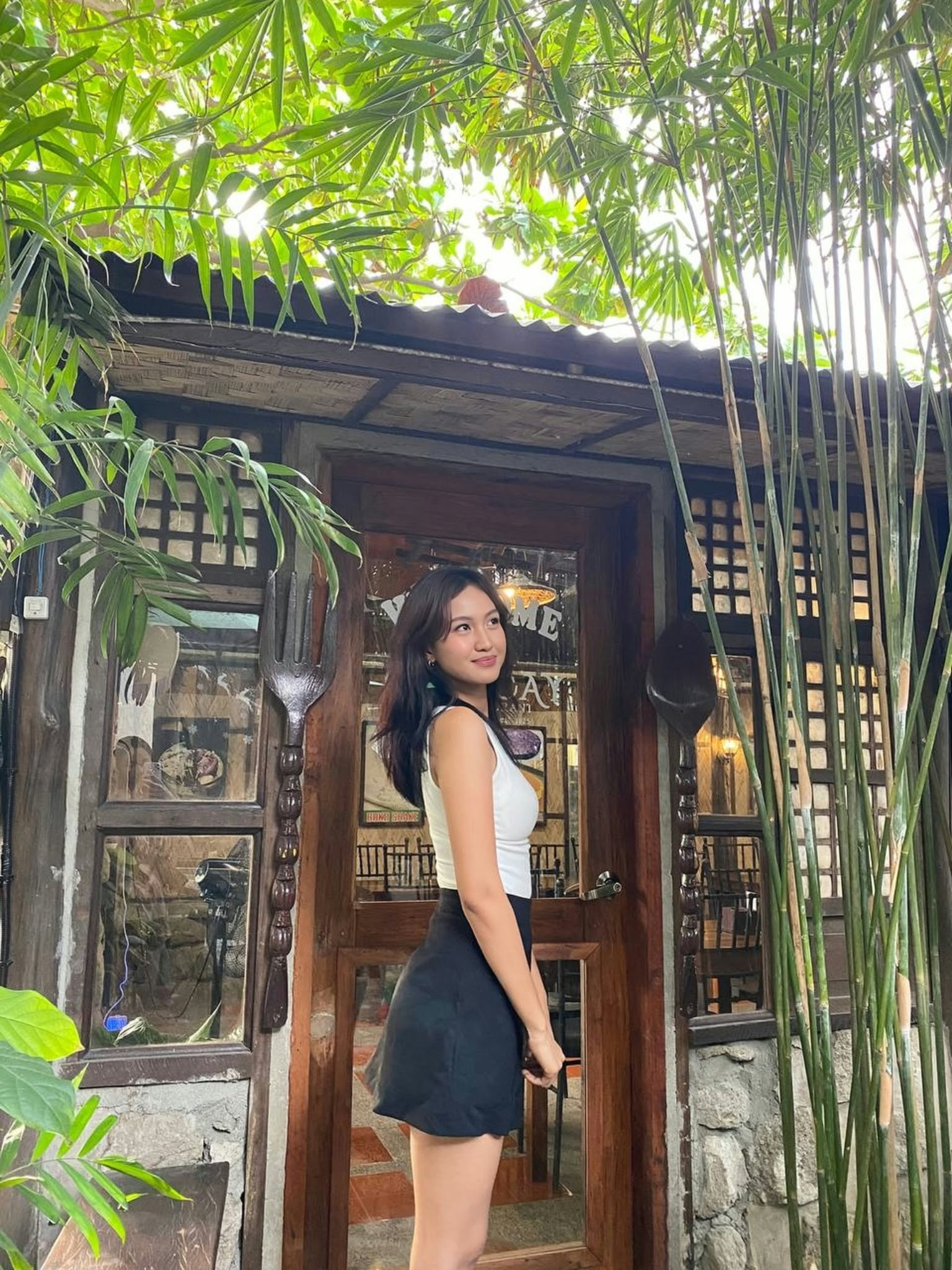Charry Mae Doria standing in front of a wooden doorway